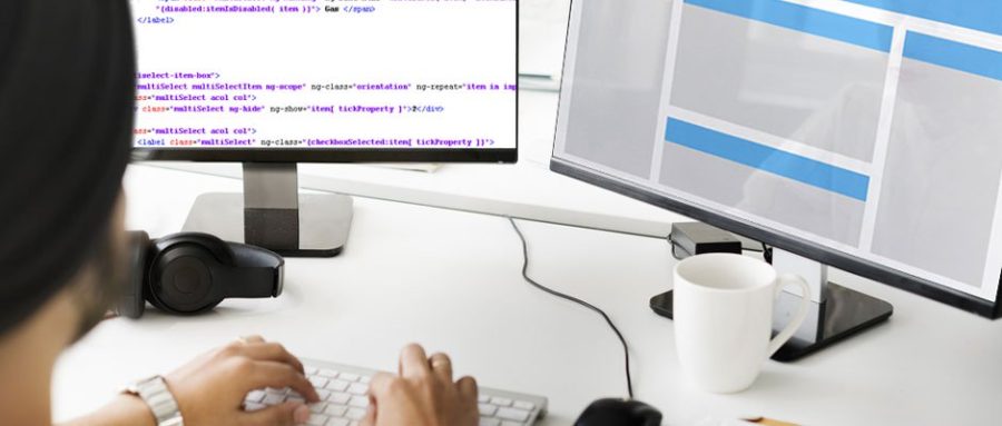 CSS developer working with two monitors, one with CSS code and the other showing a visual translation of that code