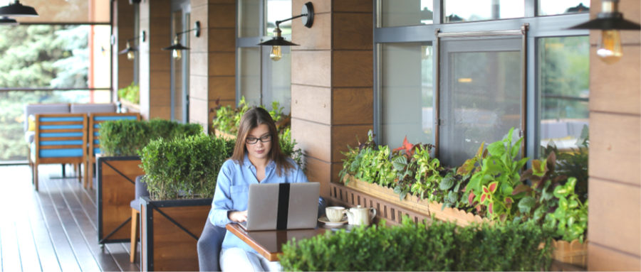 a woman working alone outside at a coffee shop