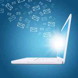 Laptop with envelopes coming out of the screen.