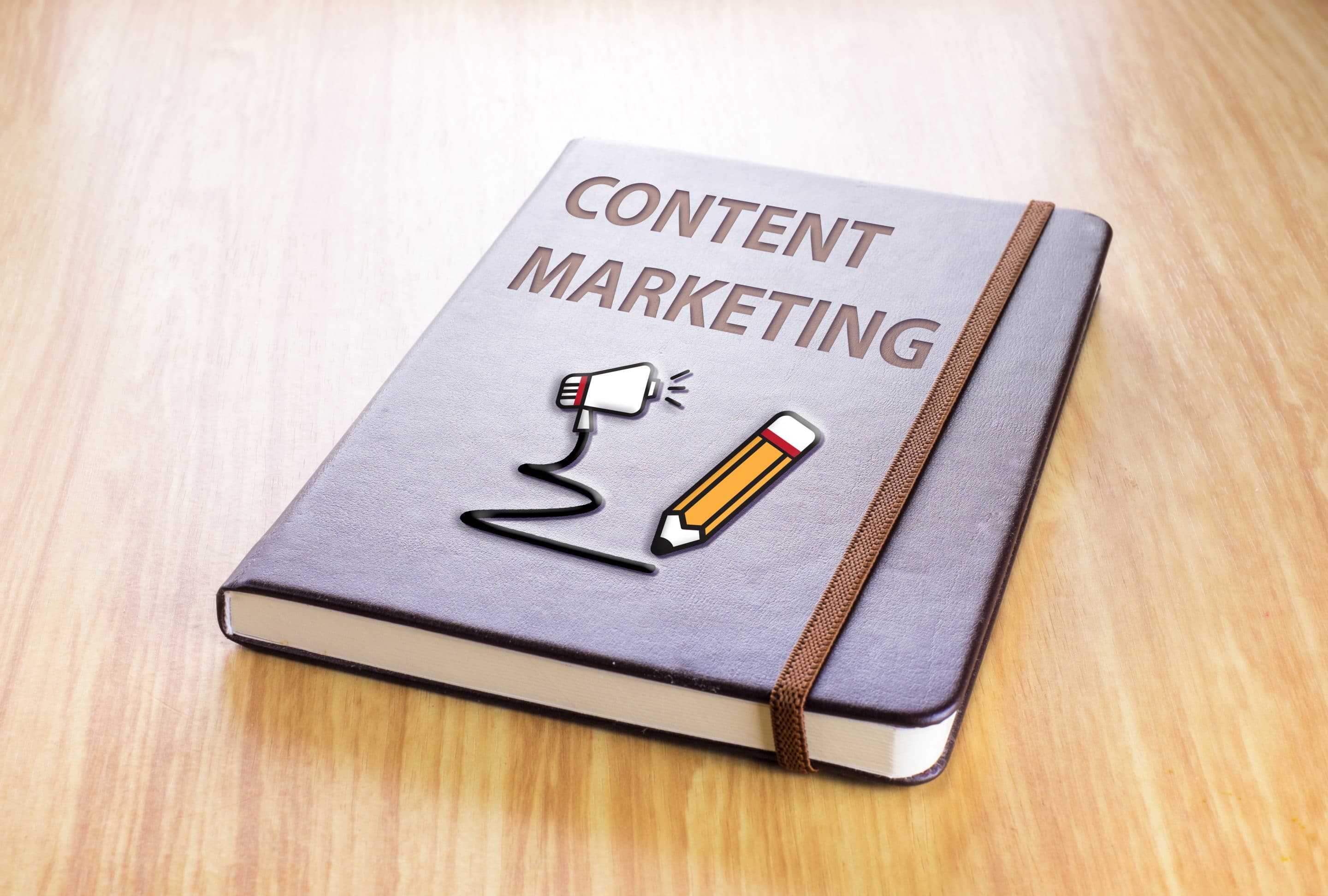Brown notebook with Content marketing word and pencil with speaker icon on wood table, Technology concept.