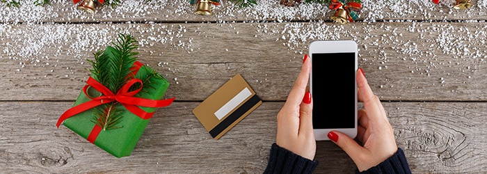 Woman-shopping-online-for-christmas-on-smartphone-862267256_700x250