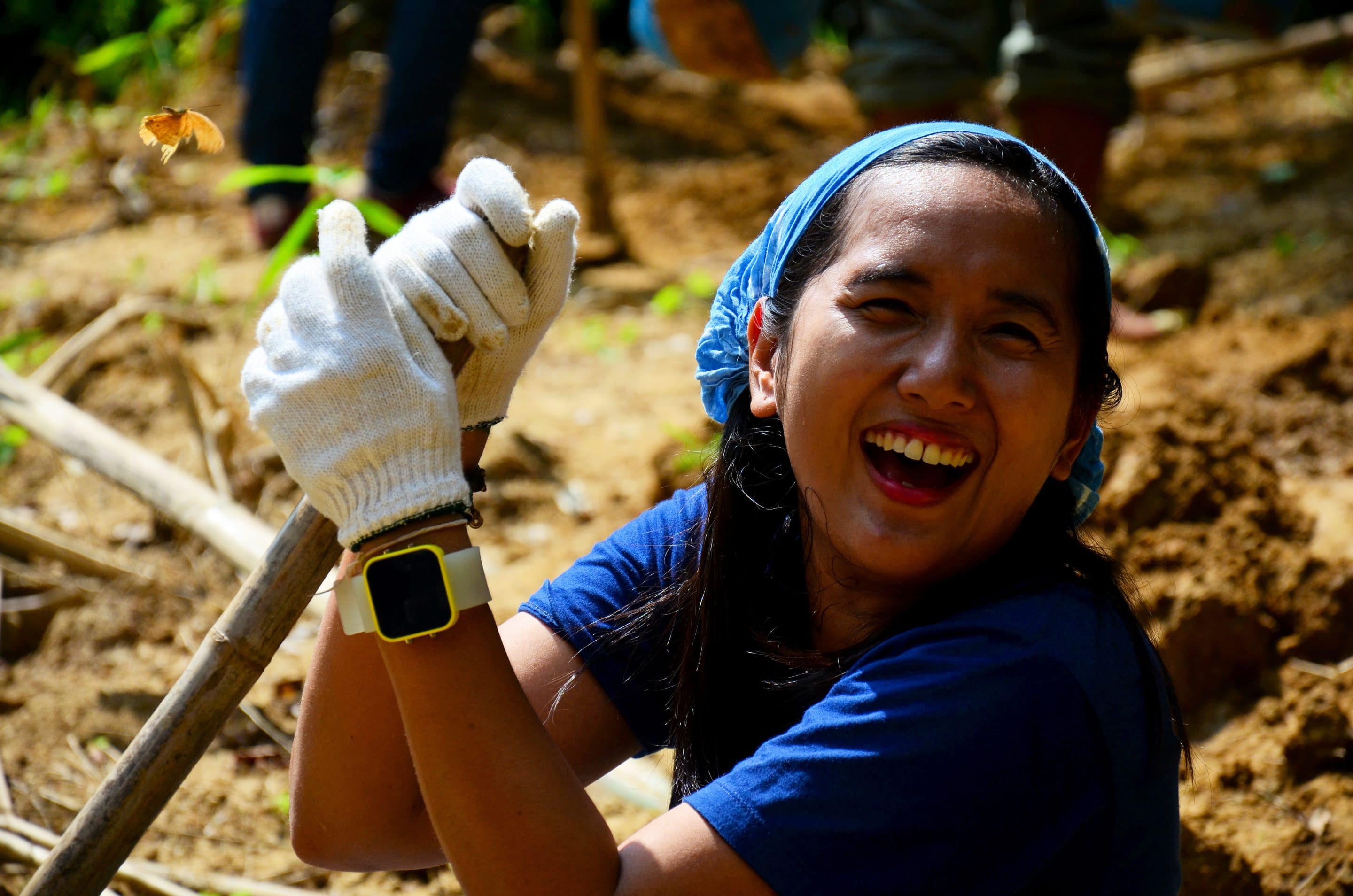 A smiling young girl volunteering. 