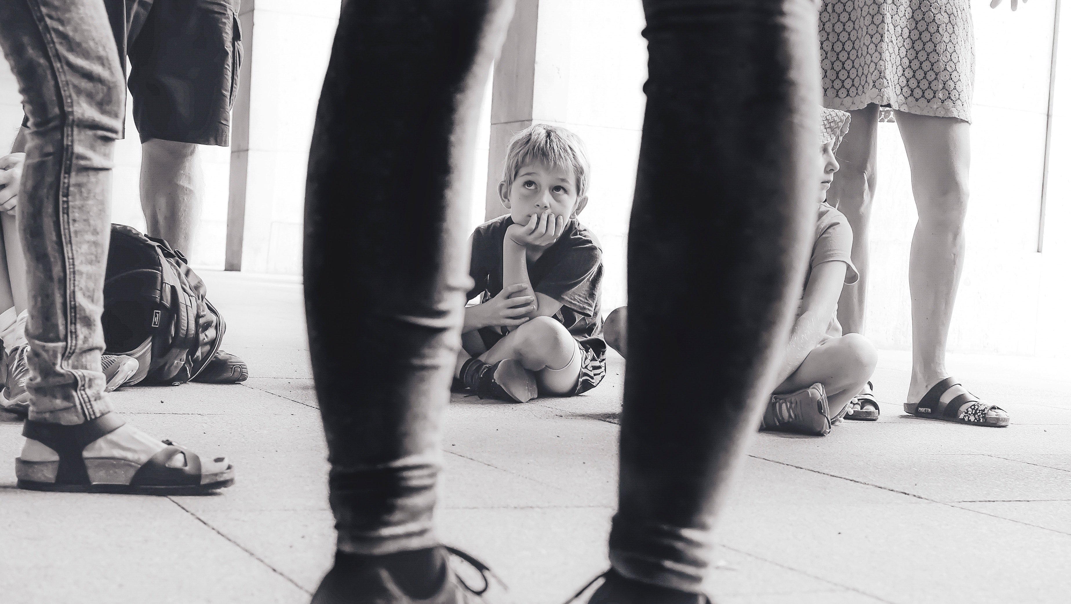 young boy listening to adults in why the first thing a new marketing manager does is critical