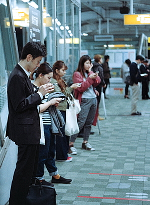 people on phones illustrating 10 Tips to Improve Your Websites SEO Ranking