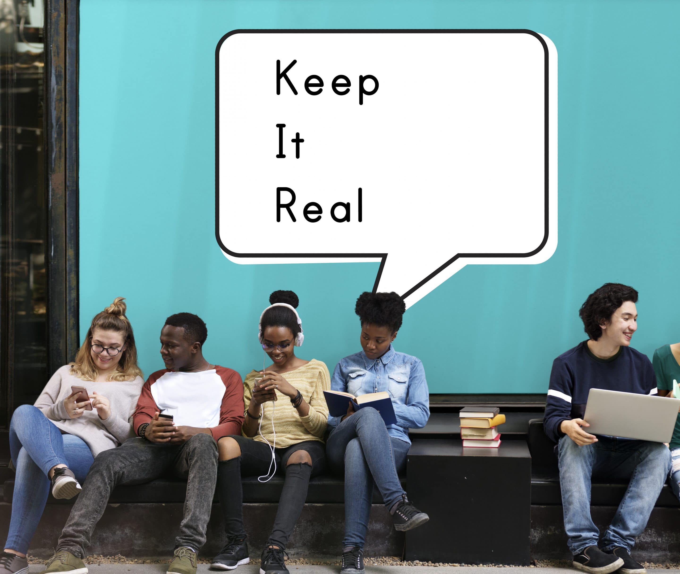 Kids sitting on a bench under a "keep it real" sign showing what authentic social media branding is.