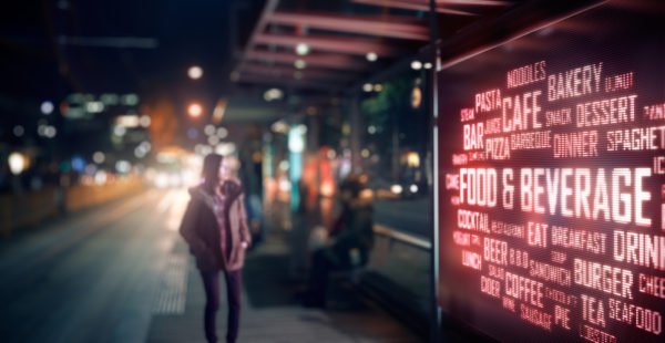 man staring at street billboard with outdoor advertising technology