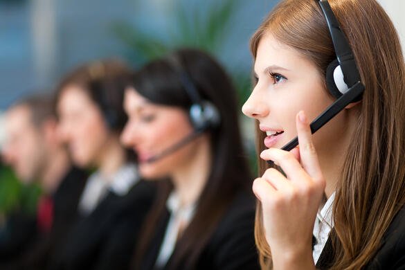 Woman answering customer phone call at a call center
