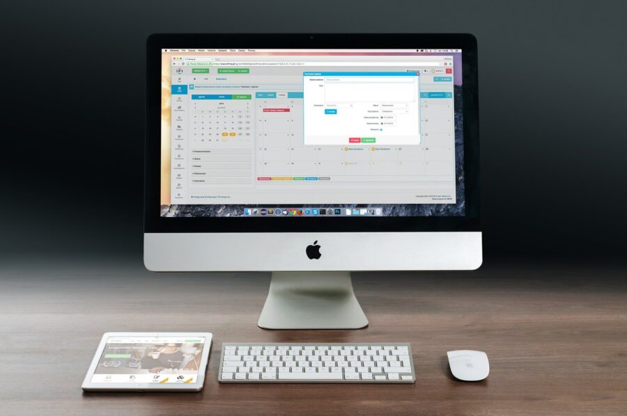 A computer monitor showing a calendar and a task management system.