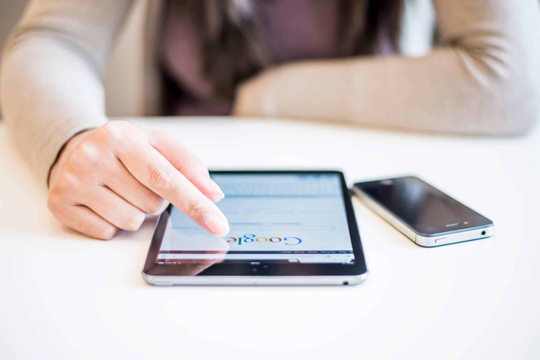Woman using Google on iPad.