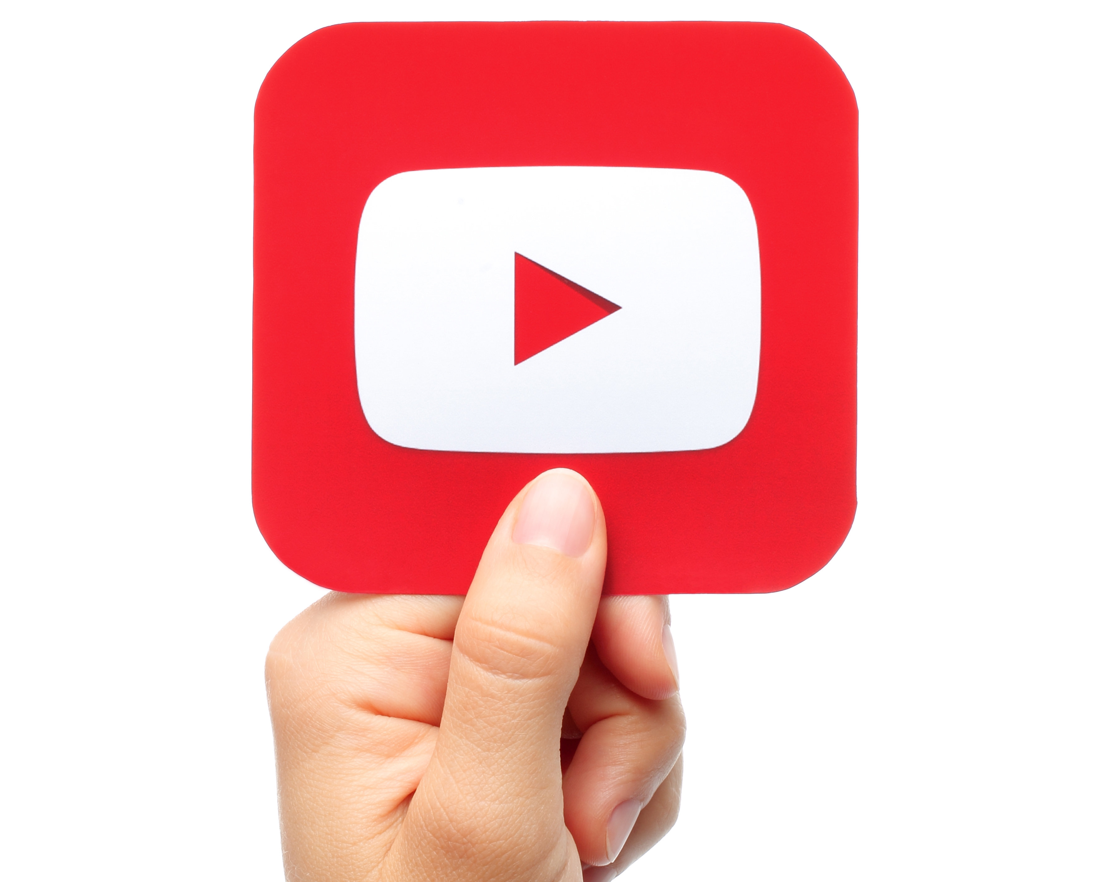 YouTube logo being held by someones hand. 