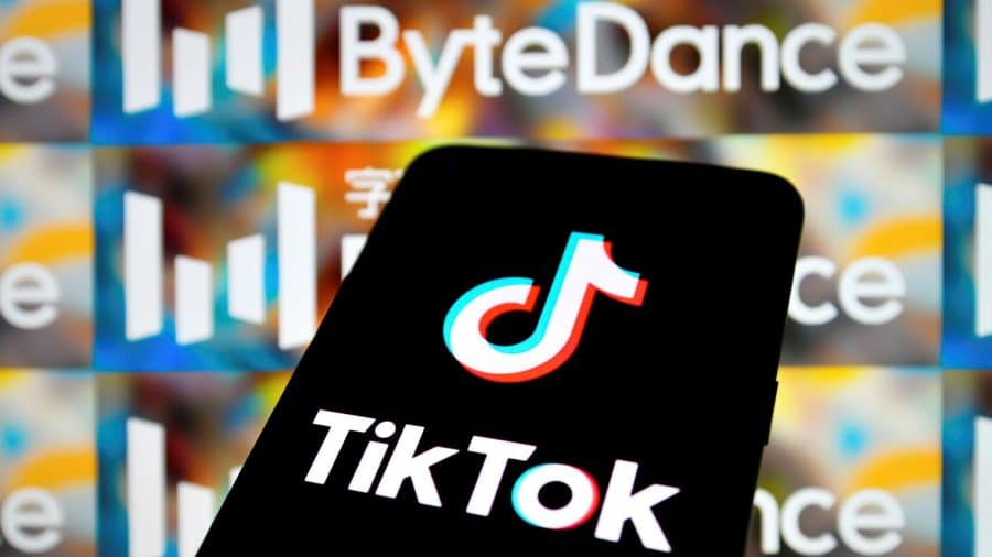 TikTok on a phone in front of ByteDance logos