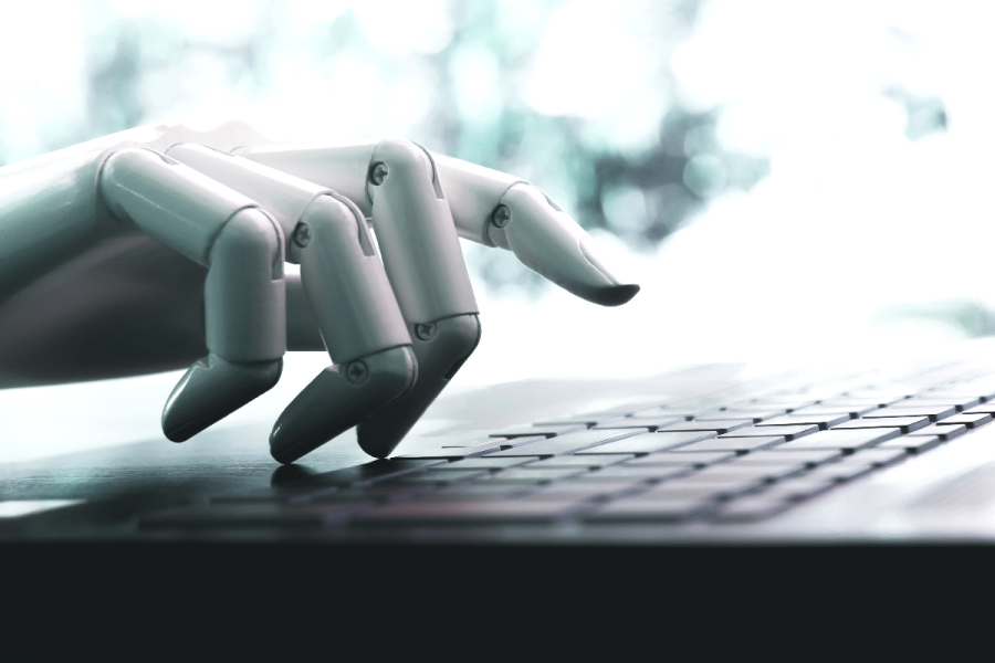 AI writing tools: Robot concept or robot hand chatbot pressing computer keyboard enter