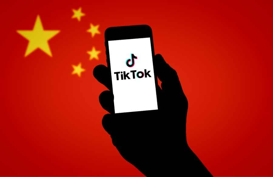 tiktok logo on a phone in front of a chinese flag