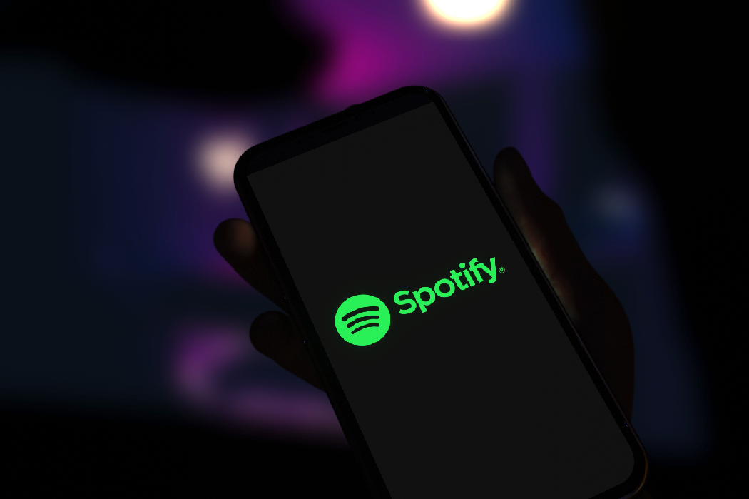 AI in music: Spotify logo displayed on smartphone screen. Editorial 3d rendering.
