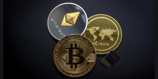 An image of Bitcoin, Ethereum, and Ripple coins.