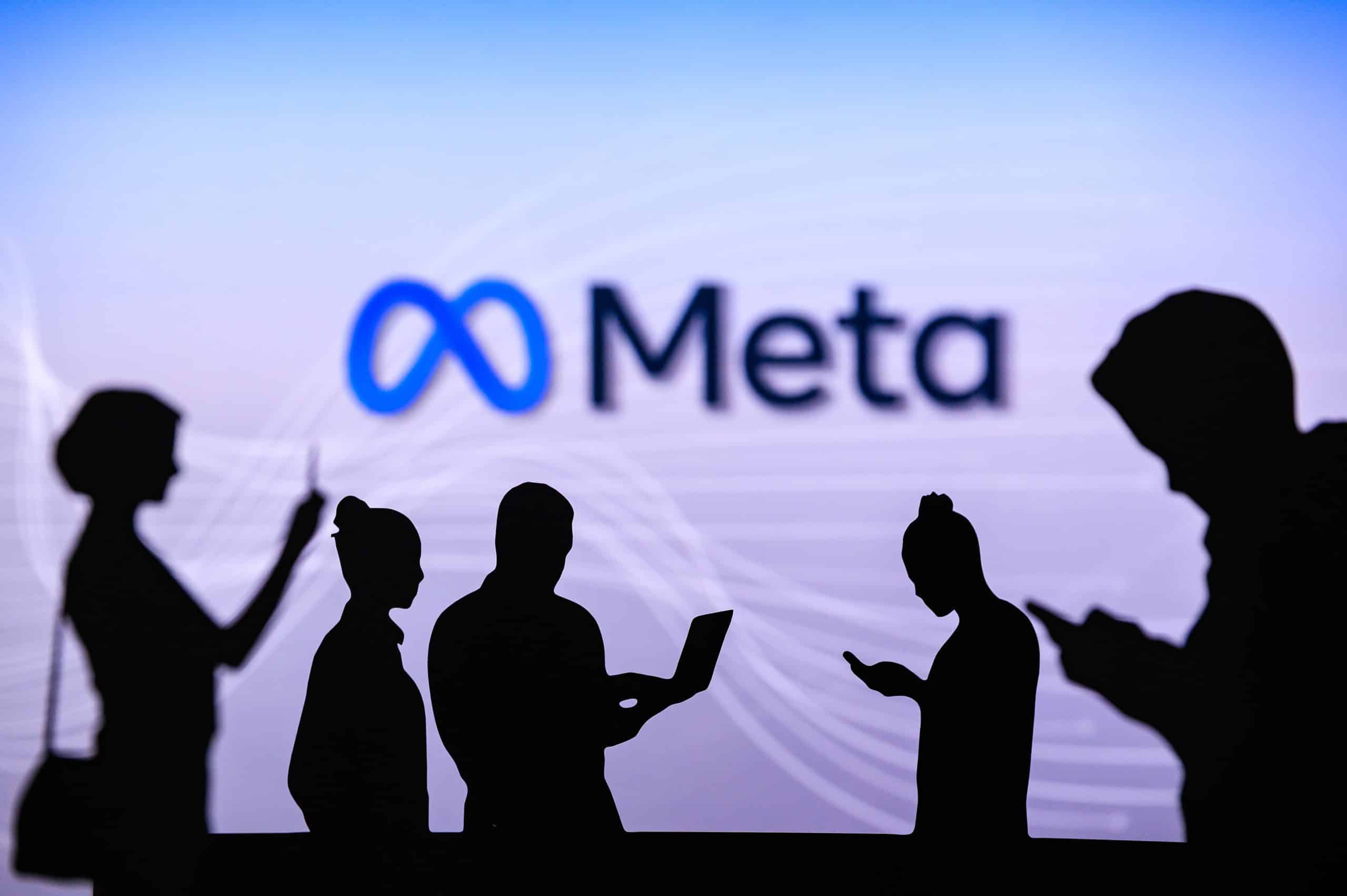 Meta logo with people in front of it