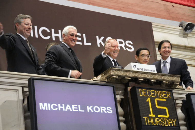 Michael Kors on wall street with colleagues