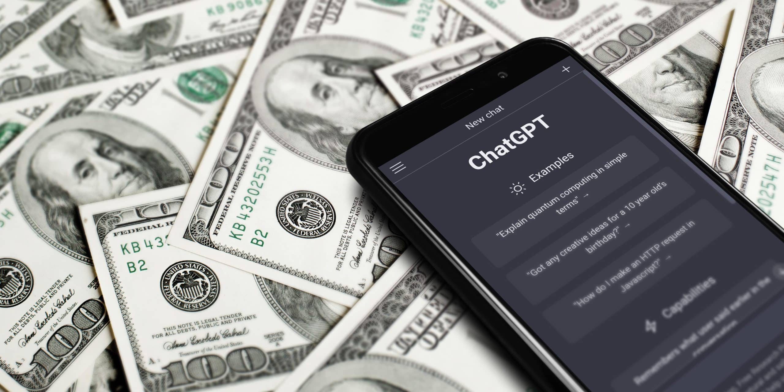 ChatGPT app on a phone on 100 dollar bills