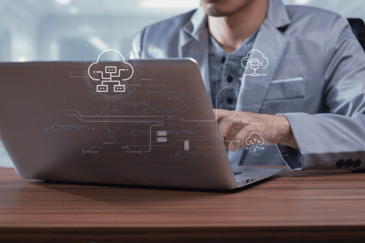 House approves bill extending small business research programs. Business professional working on laptop with cloud computing cybersecurity and data network technology interface overlay, representing secure digital infrastructure and innovation systems