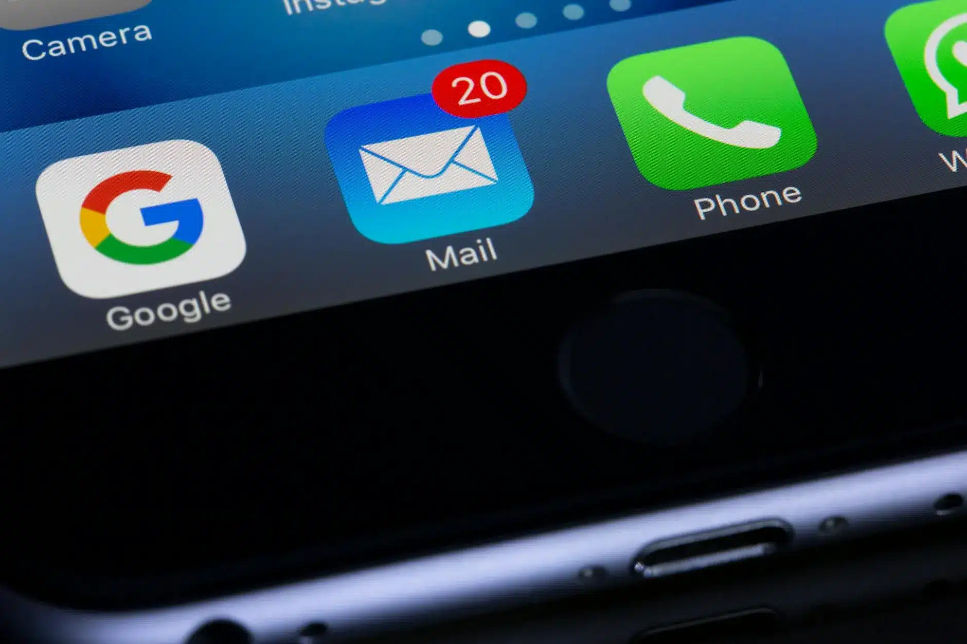 Close-up of a smartphone screen showing email app with 20 unread messages.