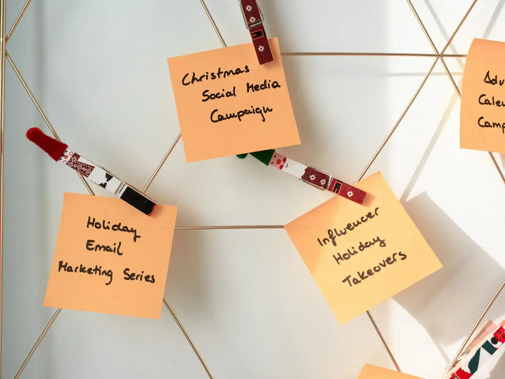 Sticky notes on a board listing email marketing campaign ideas for the holidays.