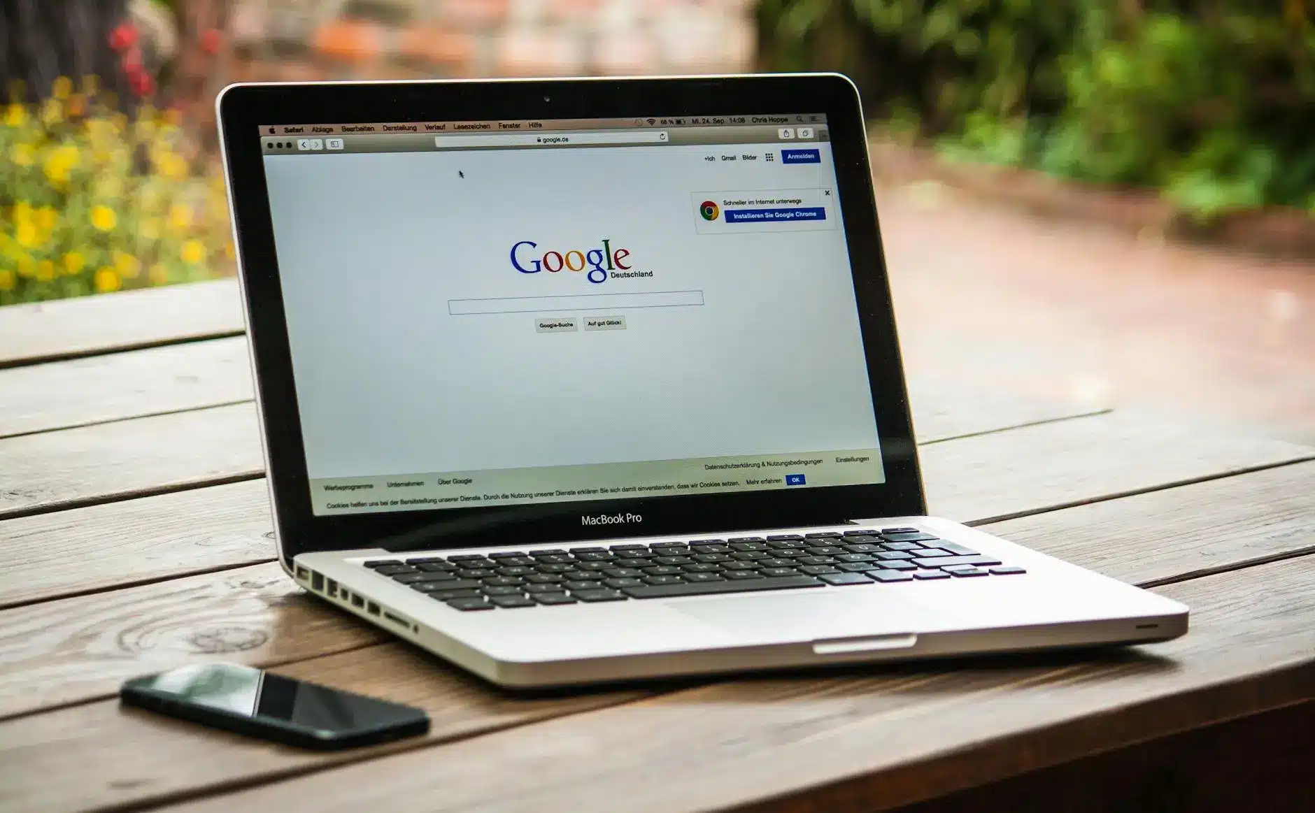 A laptop displaying Google's search engine interface outdoors.