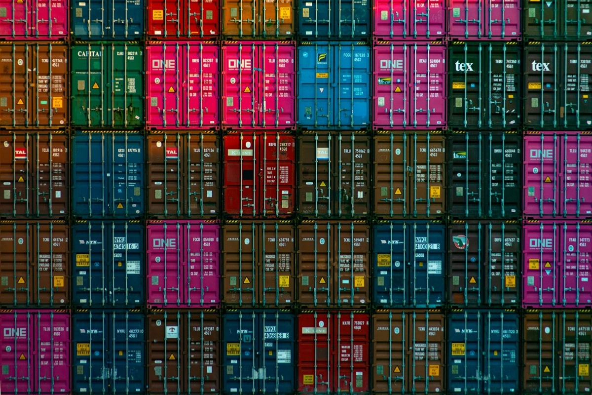 An artistic picture of stacks of various color shipping containers.